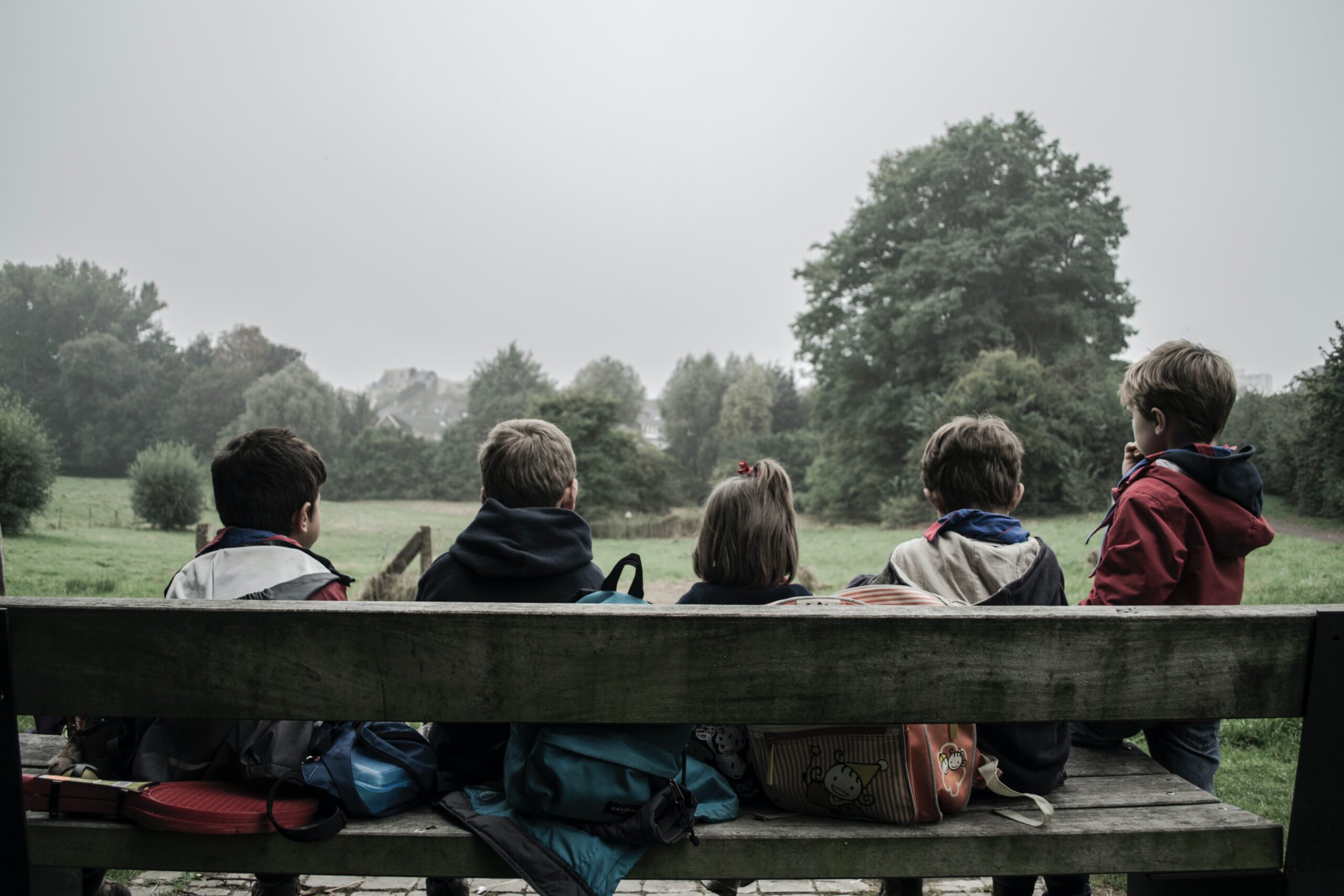 Picture of children quietly sitting on a bench